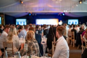 Real People. Real Growth. Affinia. Employees at group event. Our people and our community webpage.