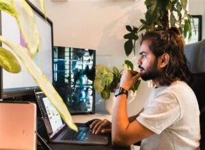 man looking at computer screens