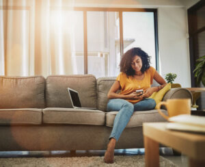 lady on sofa looking at phone