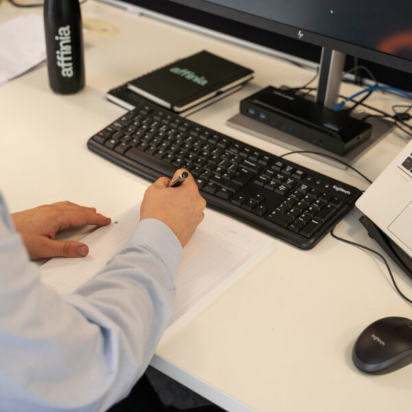 person at desk making notes
