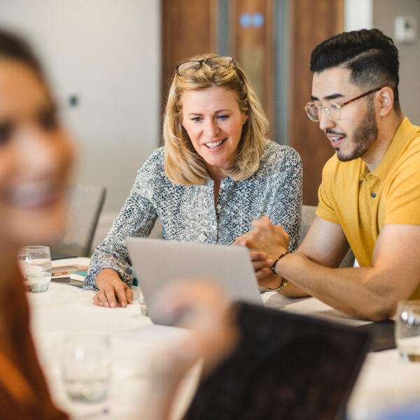 man and woman looking at laptop