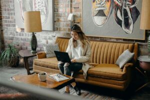 Lady on sofa looking laptop
