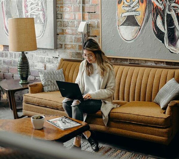 Lady on sofa looking laptop