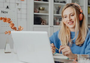 woman at laptop with headphones on